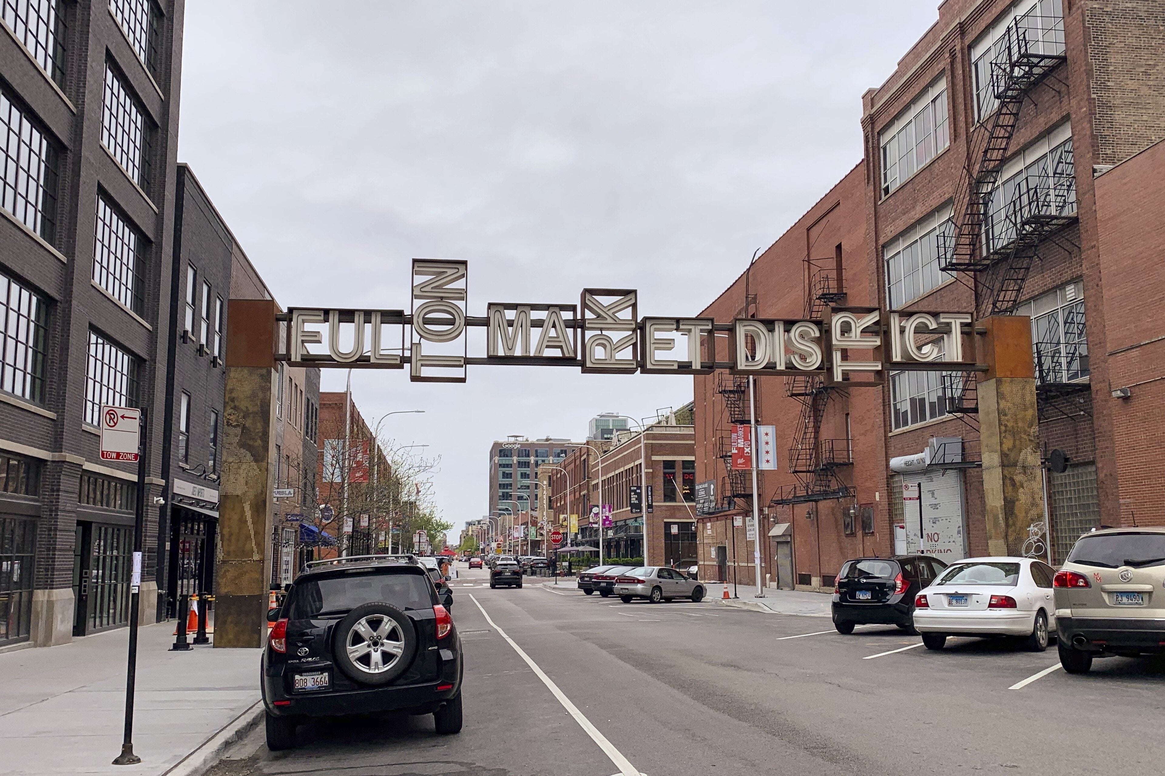 The Fulton Market sign arching over Fulton Market street in the West Loop