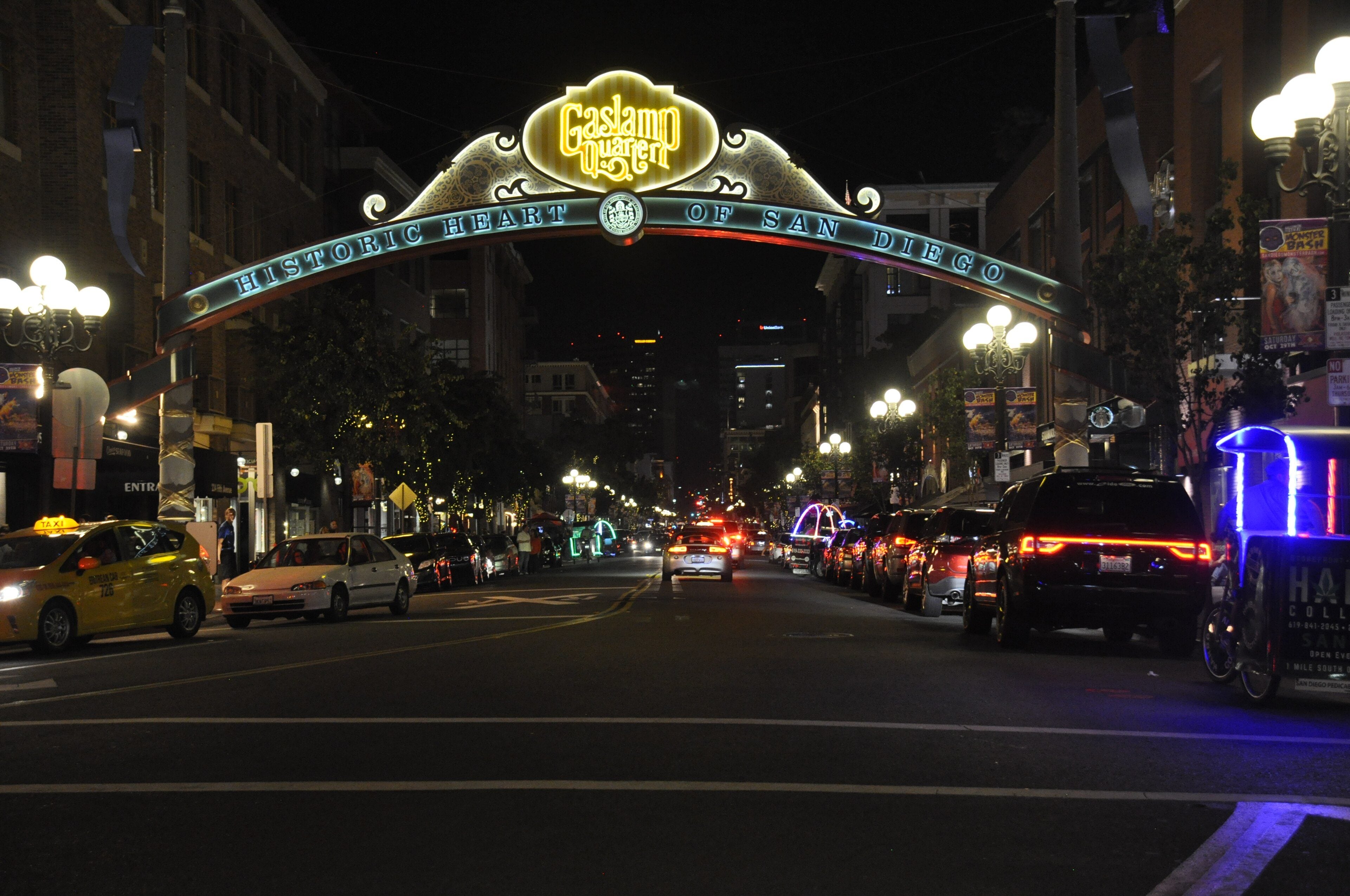 The lit Gaslamp Quarter arch over Fifth Avenue at night