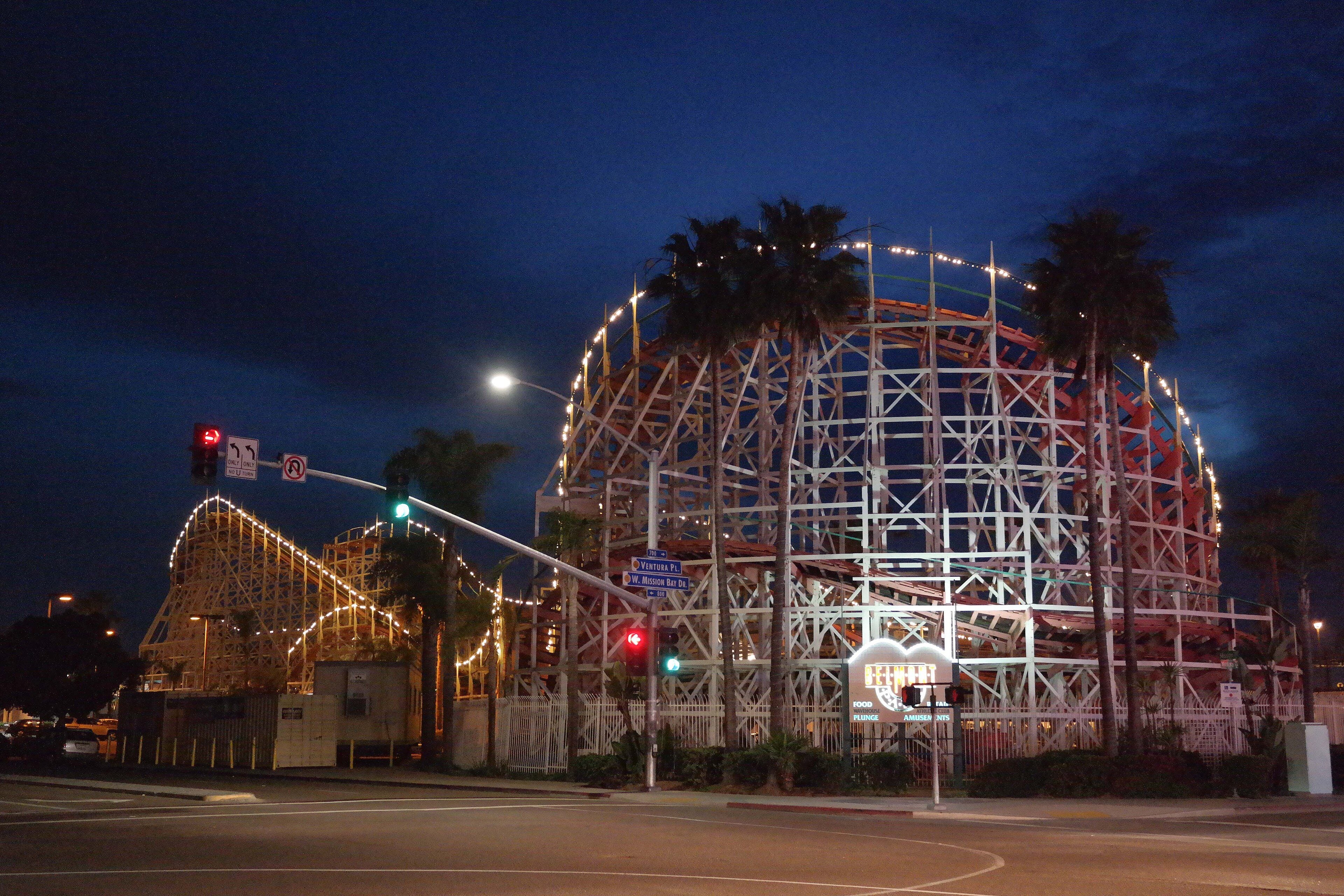 The wooden Giant Dipper roller coaster at Belmont Park lit at night