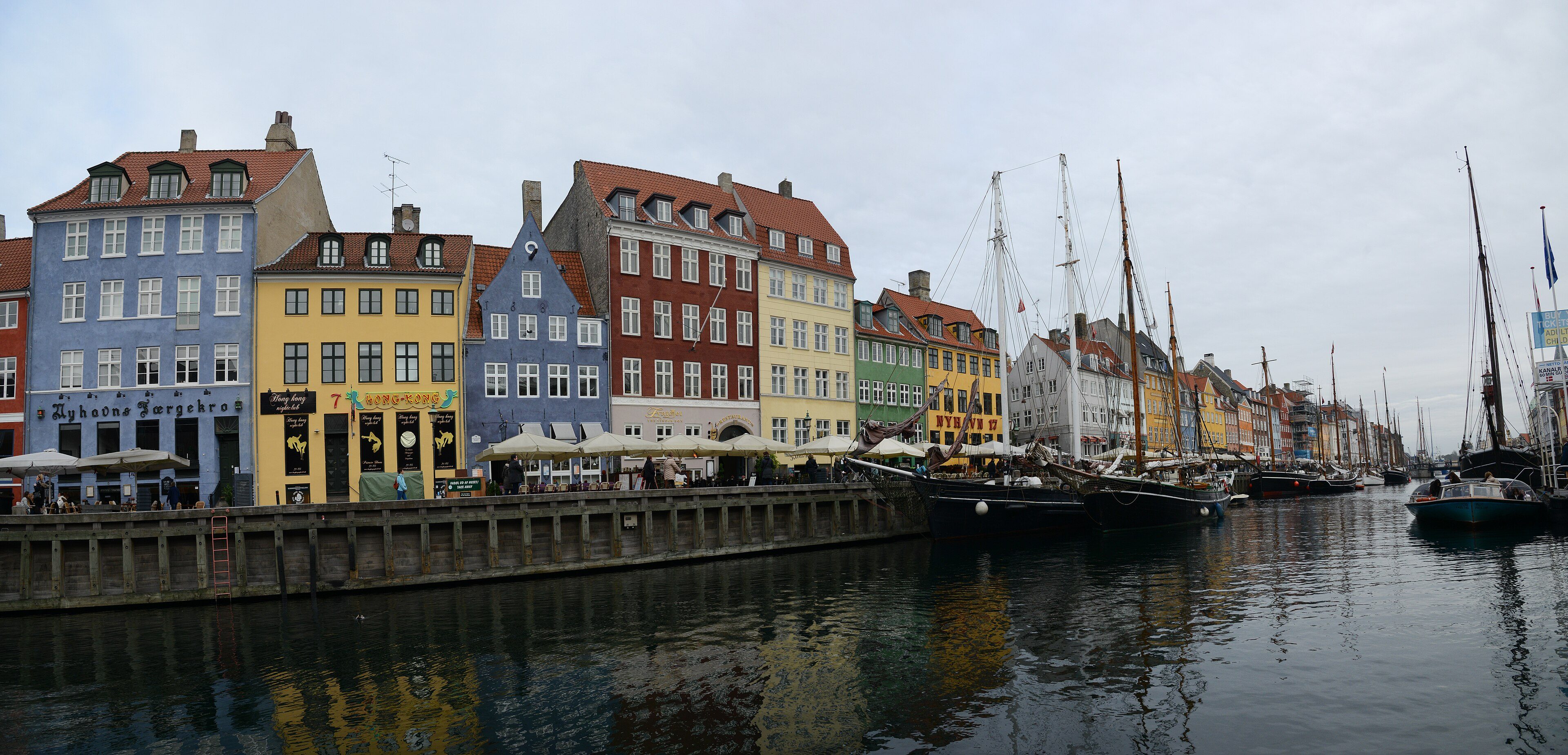 Panorama of Nyhavn's painted townhouses and old boats