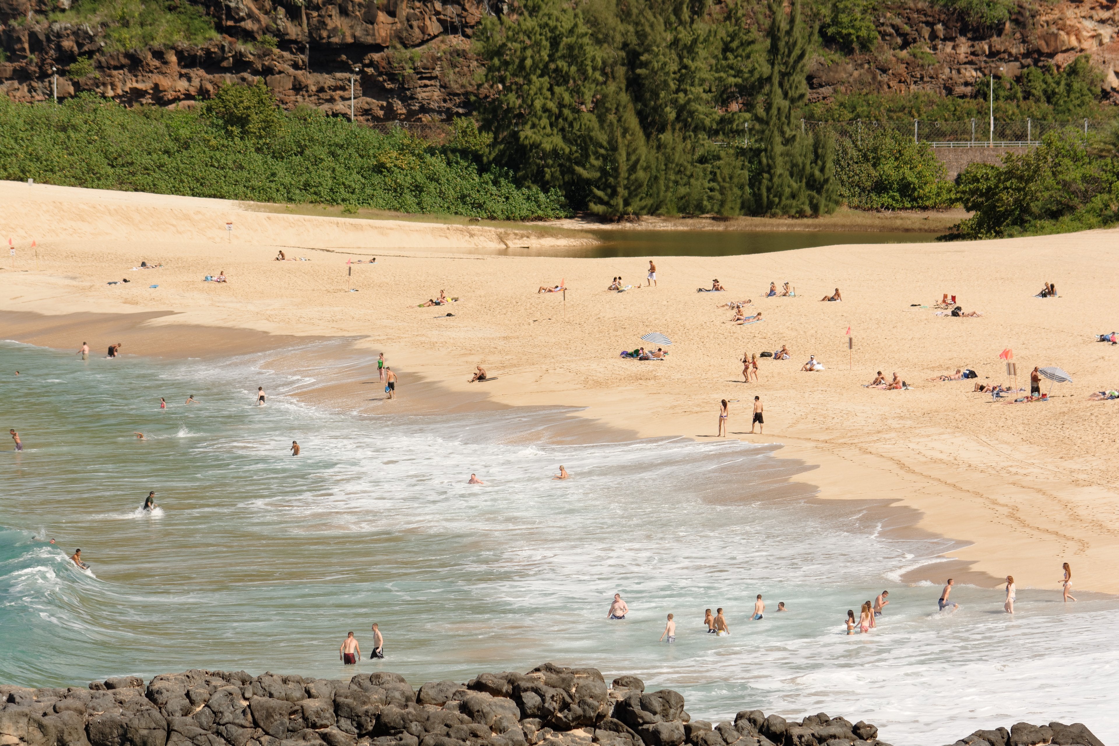 The sand and cliffs at Waimea Bay