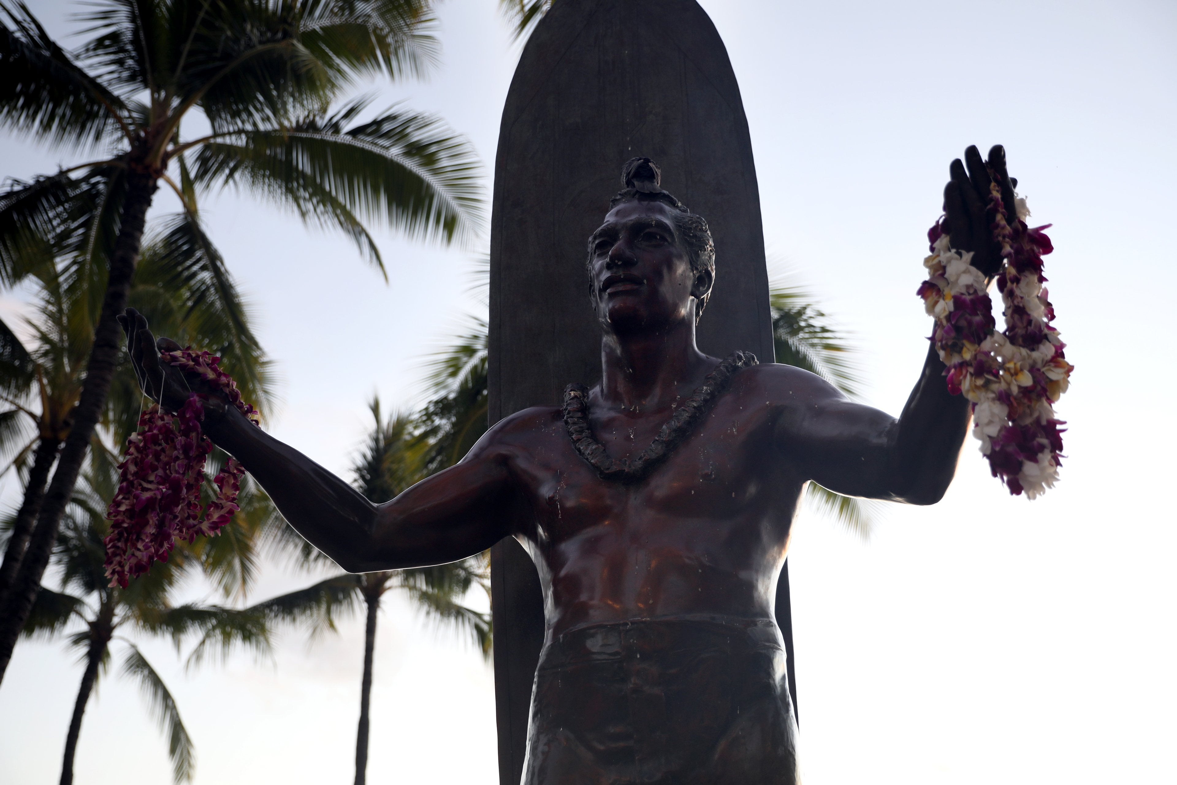 The Duke Kahanamoku statue draped in leis on Waikīkī Beach