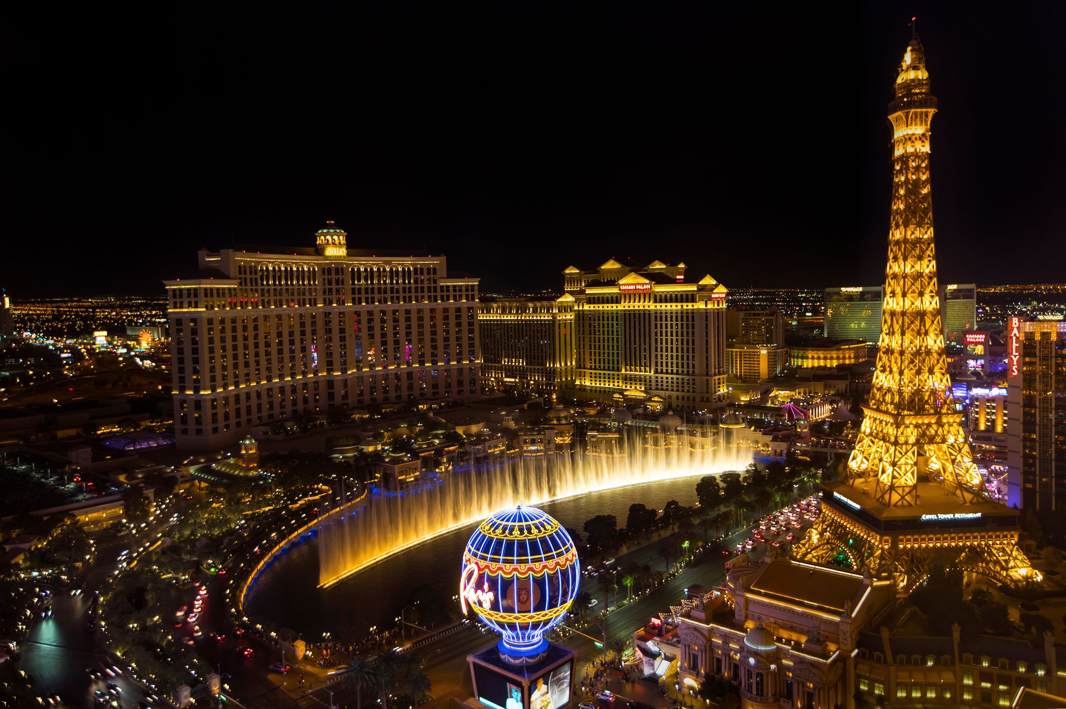 The Las Vegas Strip at night from above: Bellagio fountains, the Paris Eiffel Tower and the lit-up hotel row