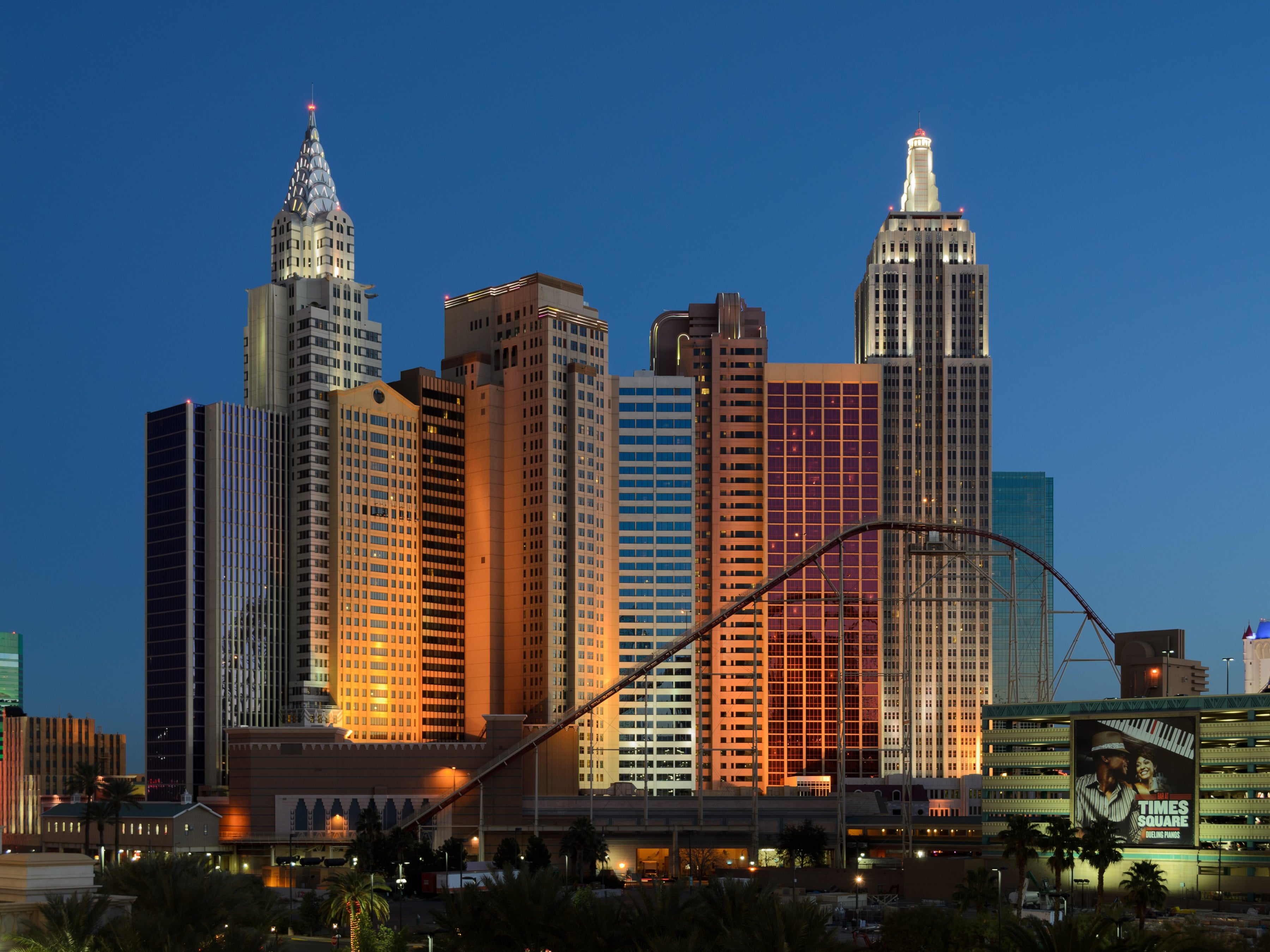 New York-New York's mini Manhattan skyline and roller coaster lit at dusk