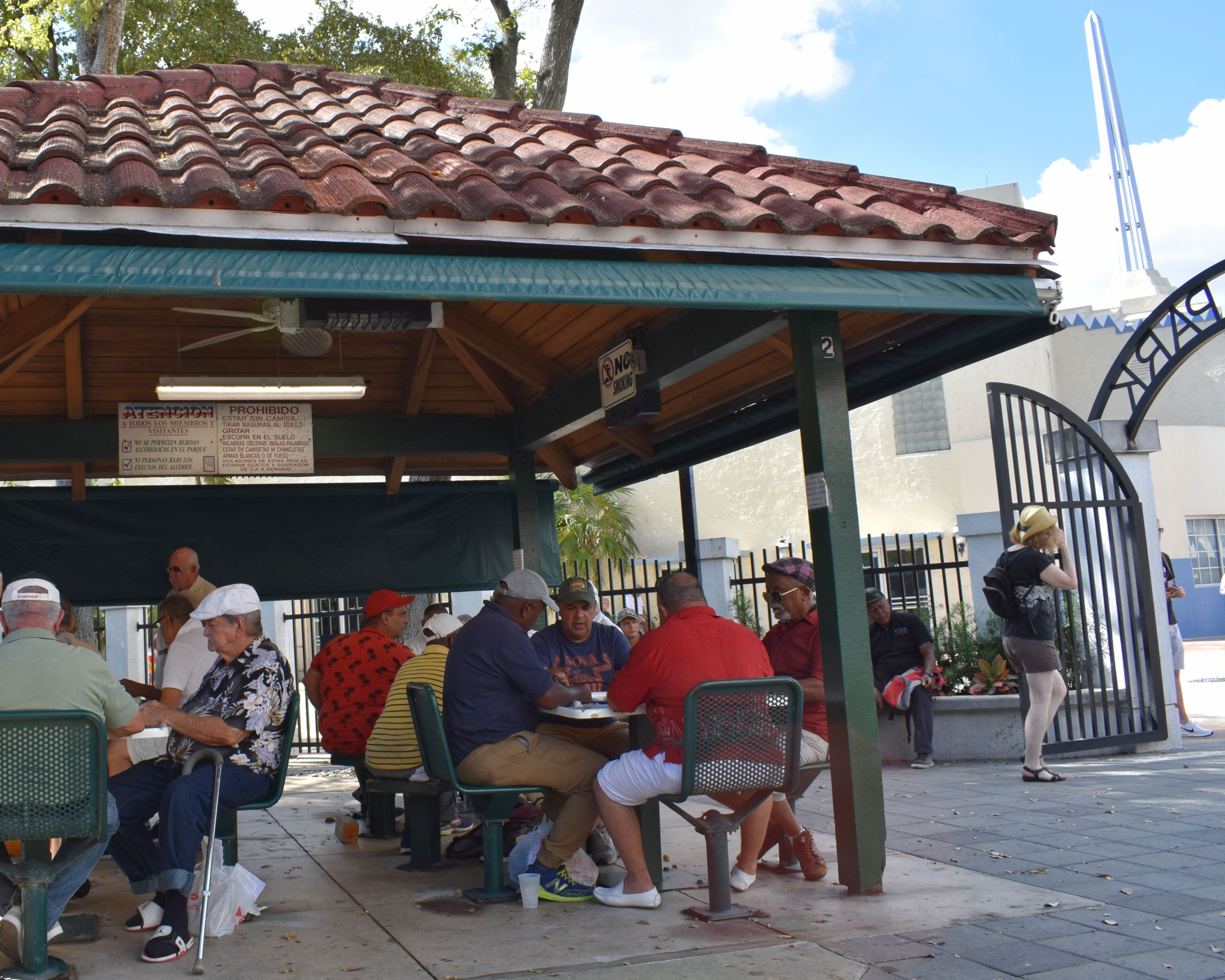 Men playing dominoes under the pavilion at Máximo Gómez Park