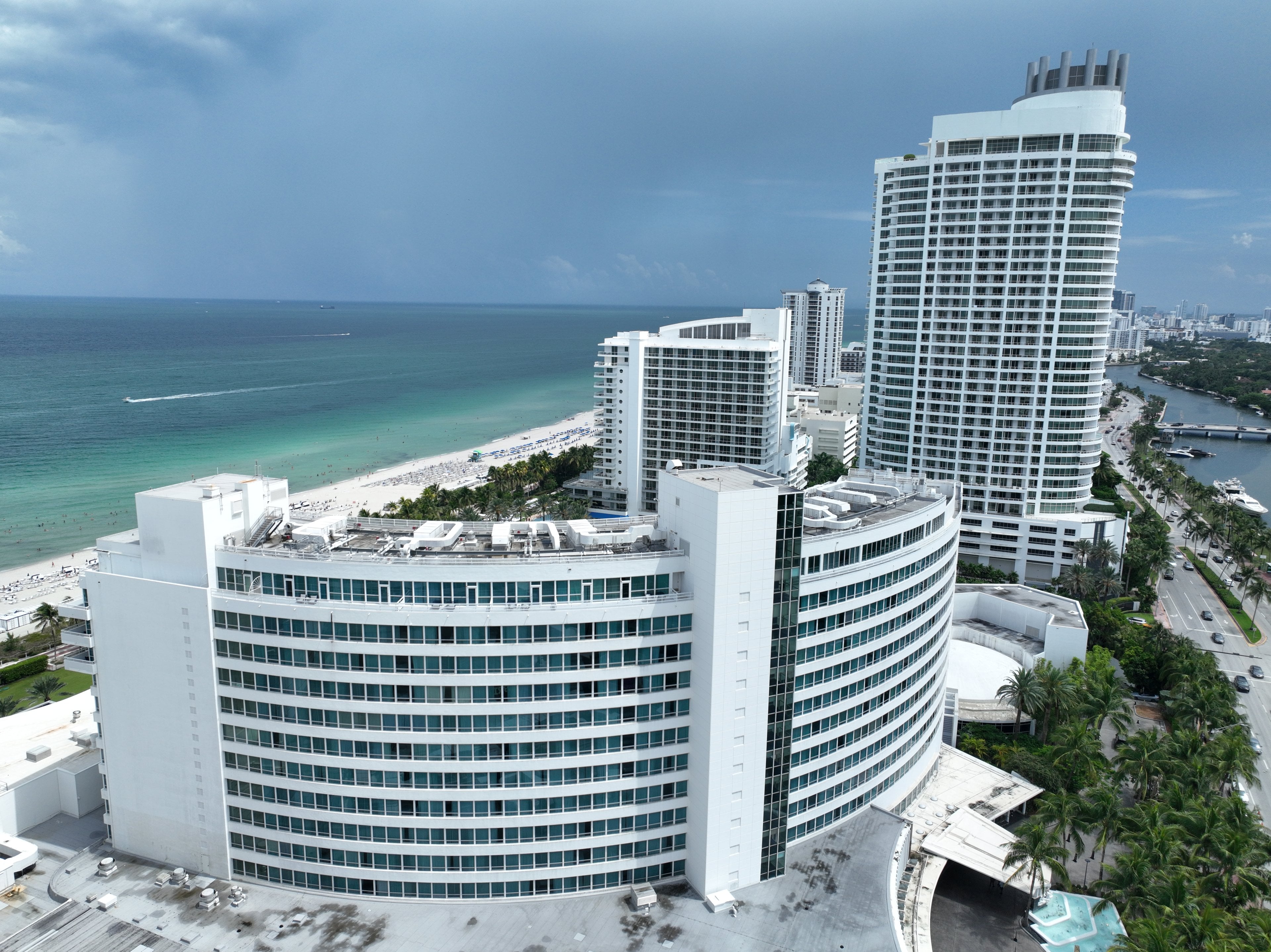 Aerial view of the curved Fontainebleau hotel on the beach in Mid-Beach