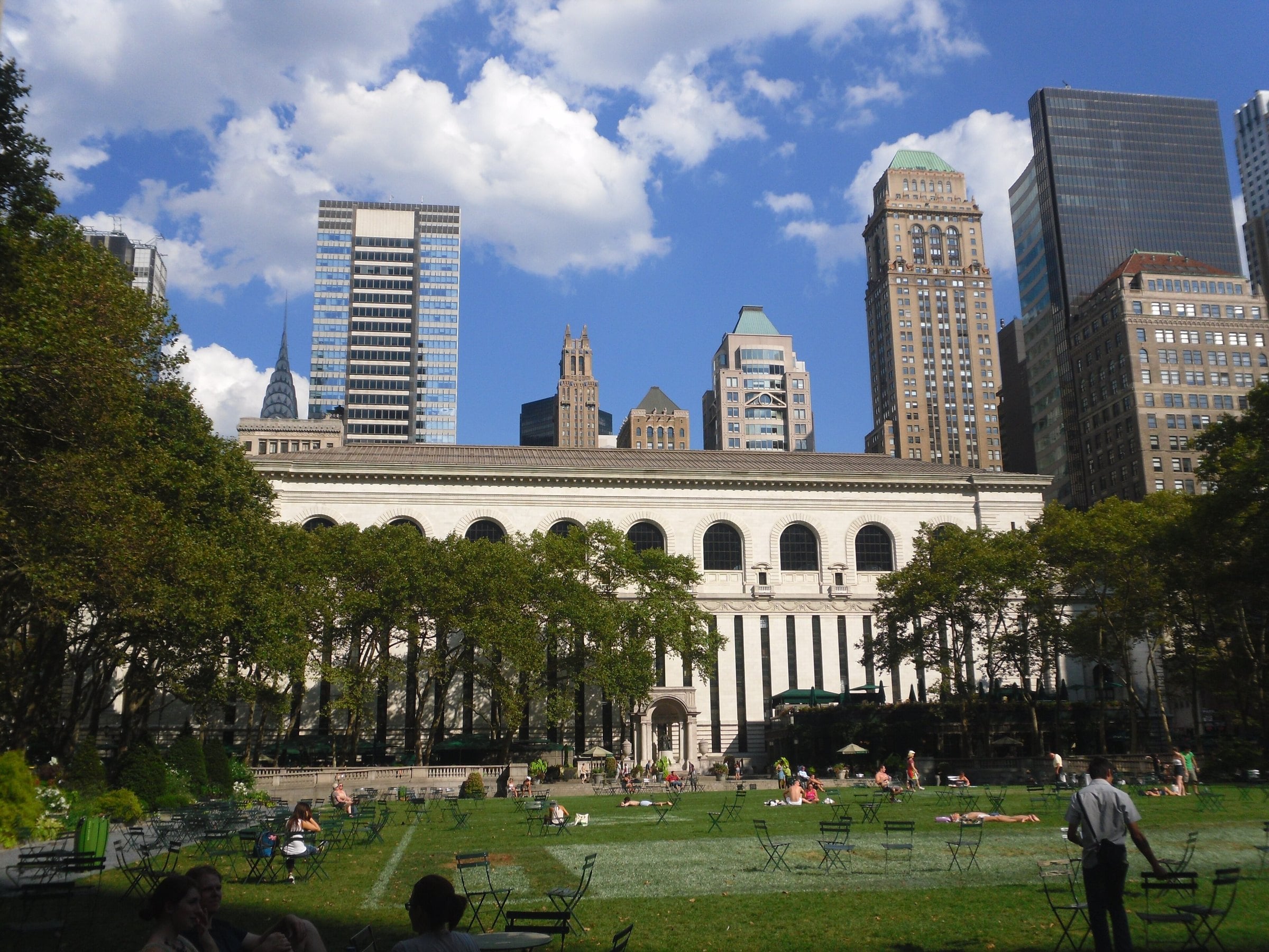 Bryant Park lawn and the New York Public Library under blue sky