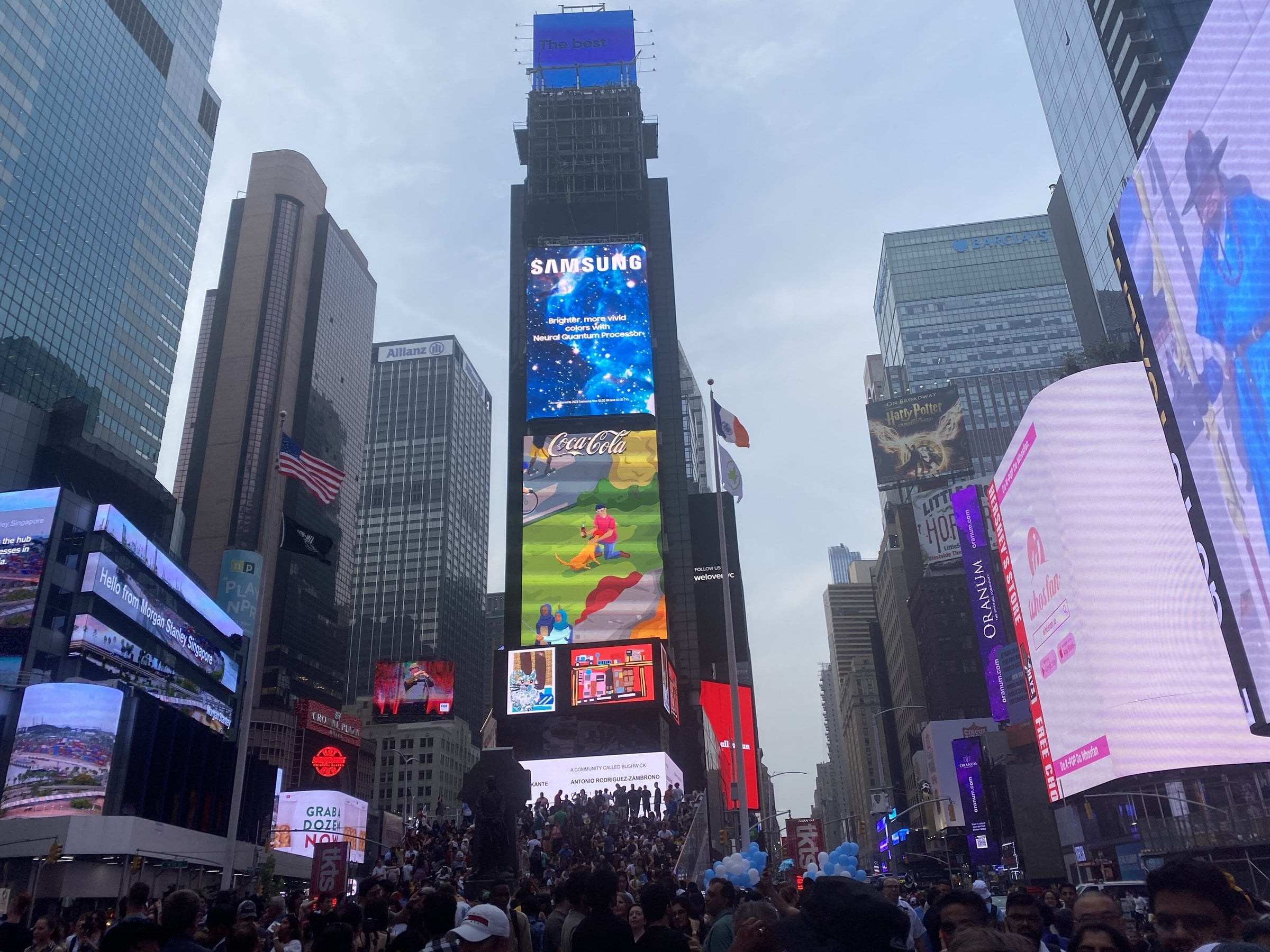 Times Square billboards and crowds on a bright day