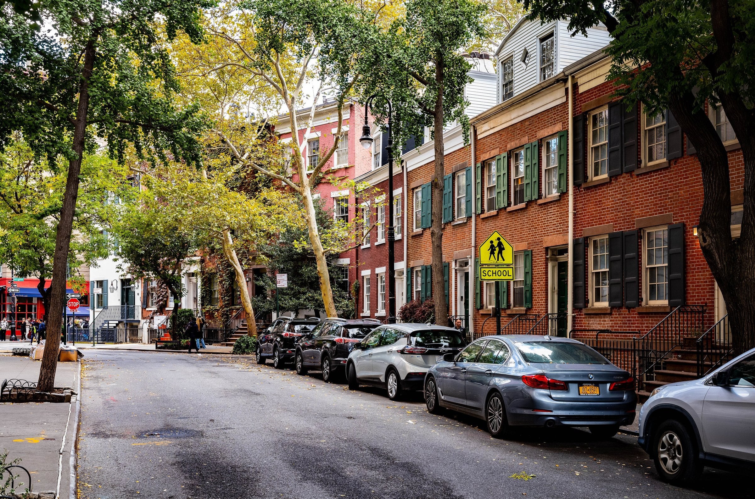 Tree-lined Grove Street with brick townhouses in Greenwich Village