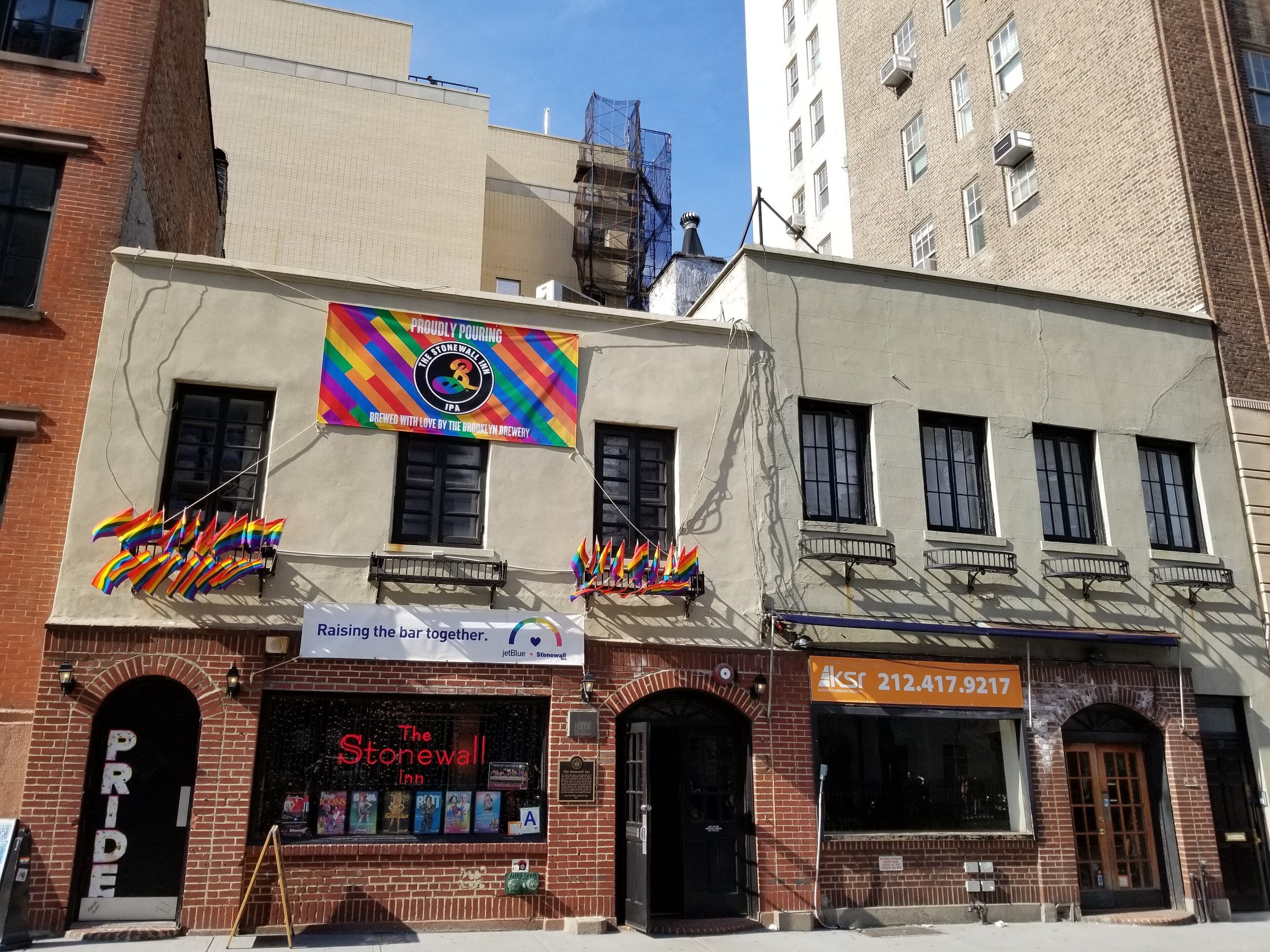 Stonewall Inn facade with rainbow flags on Christopher Street